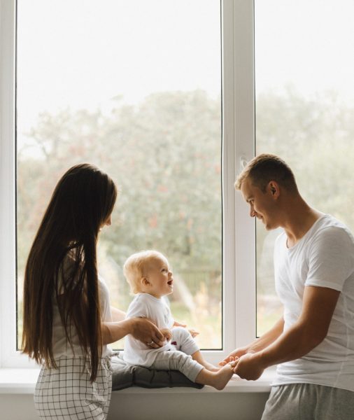 Mom and dad play with their little son